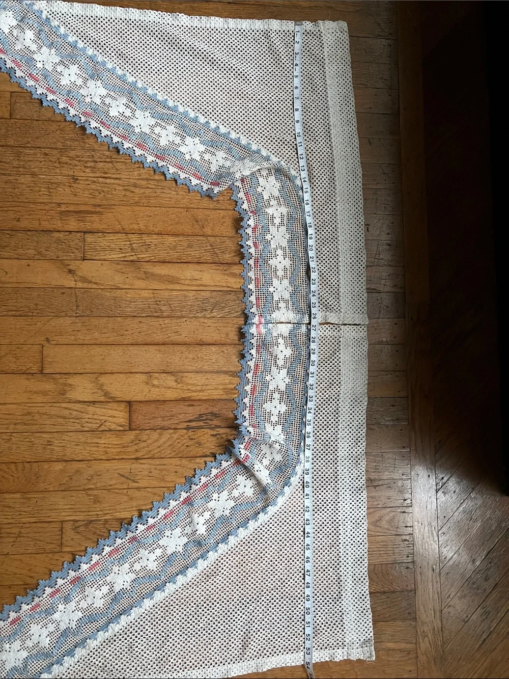Set of curtain swags, decorated with blue accents and a pink ribbon .